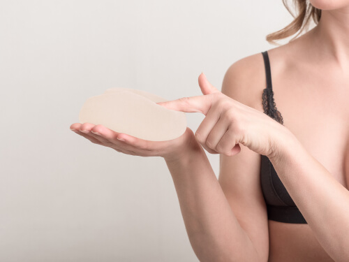 Young woman touch breast implant-img-blog