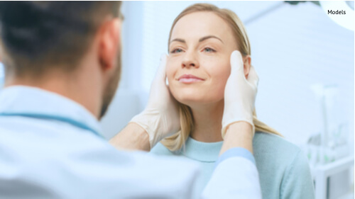 A woman at her consultation for a traditional facelift procedure to erase jowls near her mouth and wrinkles on her forehead.