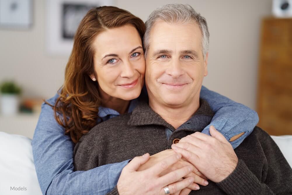  Middle aged couple relaxing at home with youthful-looking eyes.