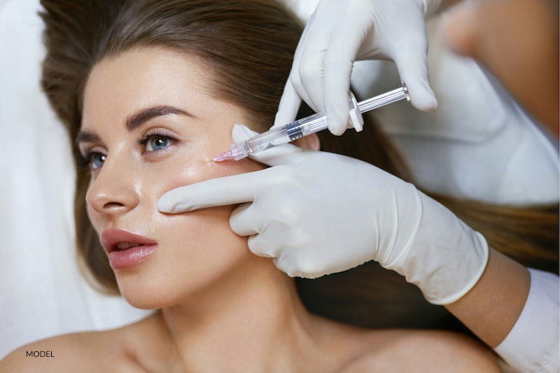 Woman getting injectable filler treatment in cheek