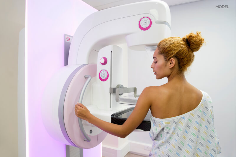 Women starting to undergo a mammogram.