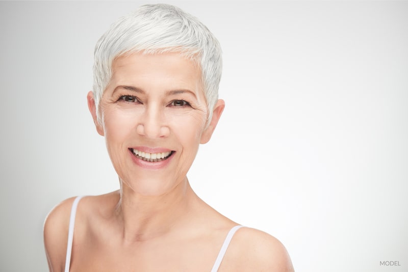 Close-up image of a middle aged women with gray hair. Facial rejuvenation concept.