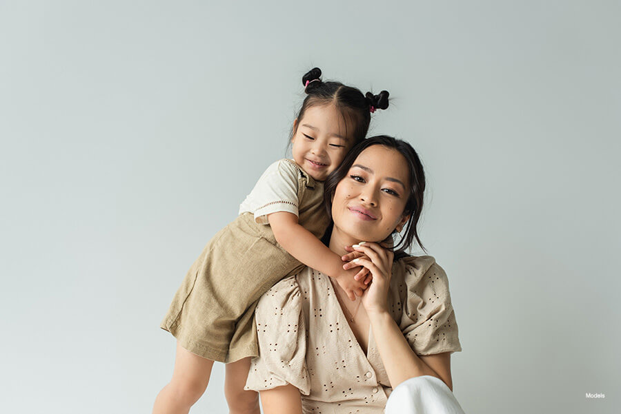 Beautiful young mother is embraced by her toddler